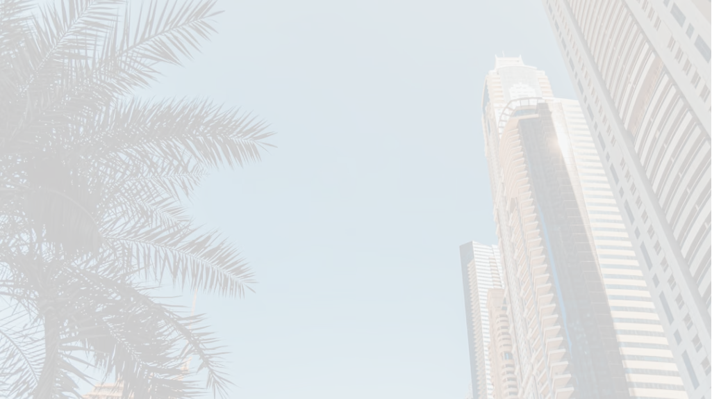Close-up architectural view of a modern skyscraper's upper section and surrounding trees.